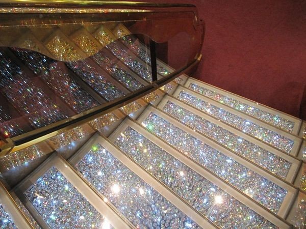 Luxurious curved staircase with crystal balusters and marble steps