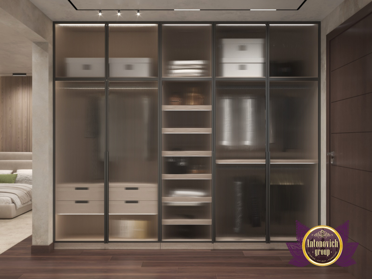 Luxurious walk-in closet with a comfortable seating area and custom cabinetry