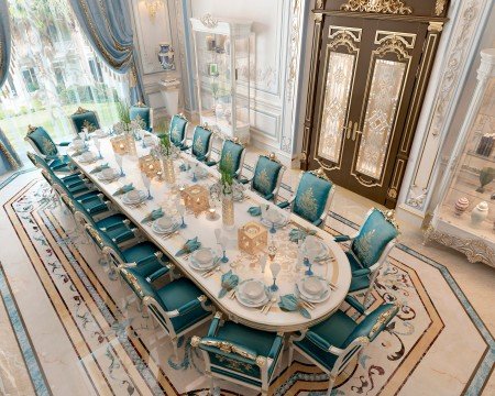 This picture shows a luxurious dining area with a curved ceiling, marble floors, and marble walls. The furniture consists of several chairs with upholstered backs, a round dining table, and a large chandelier as the centerpiece. The walls are decorated with gold and brown frames, as well as art prints.