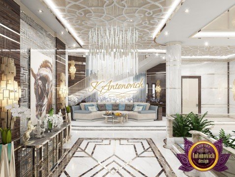 Luxurious Mediterranean living room design with grand crystal chandelier and beige furniture, creating a warm and sophisticated ambience.