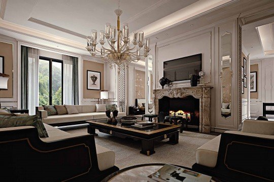 This picture shows a luxurious, modern living room. Its walls and ceiling are painted white, while the floor has a grey hardwood finish. The room features two beige armchairs and two matching sofas arranged around a large white coffee table. A glass-topped side table sits next to a round pedestal, and a wall-mounted flat-screen television is visible in the background. The room also includes several abstract art pieces on the walls and a glass-topped console table with decor pieces arranged on top.