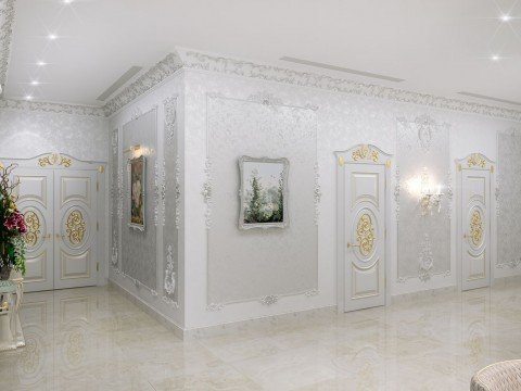 This picture shows a luxurious grand foyer with sophisticated décor. The room features a white and gold colour palette, with a marble floor and intricately patterned walls. The room is illuminated by a beautiful crystal chandelier and a large skylight window. An ornate, curved stairway with a detailed banister runs up the side of the room, leading to the upper levels. There is a seating area at the front of the room, with cream-coloured sofas and wood-panelled walls.