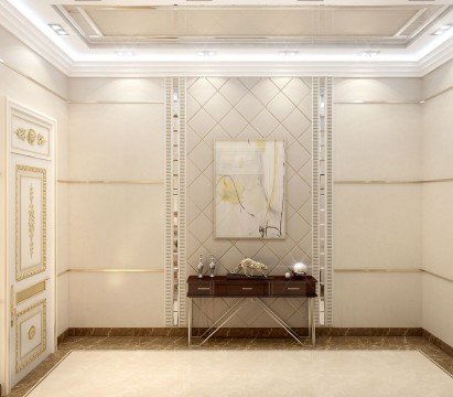 This picture shows the interior of a luxurious bedroom in a home. The room is decorated with modern, elegant furniture including a four-poster bed, two chairs, and a white dresser. The walls are painted a light cream color and the floors are hardwood. There is a dark green duvet on the bed and matching curtains with gold embroidery that hangs over the bed and window. The bed is decorated with several decorative pillows and other accents that give the room a cozy, inviting atmosphere.