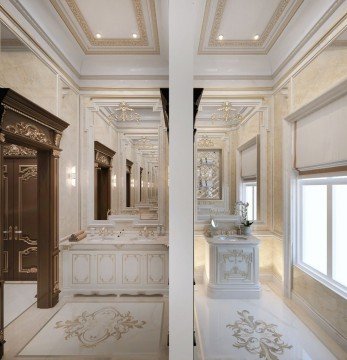This picture shows a luxurious, modern bathroom with marble styled walls and flooring. The room is beautifully decorated with detailed crown moulding, a large chandelier light fixture and a white porcelain vessel sink on top of a large marble countertop. There are two separate shower stalls with frameless glass doors and an elegant freestanding bathtub. A unique metal framed mirror hangs on the wall, adding an extra touch of elegance to the room.
