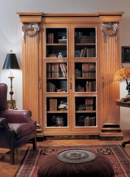 Luxurious bedroom with rich wood furnishing, velvet upholstered bed and sparkly wall accents for an elegant, yet cozy atmosphere.