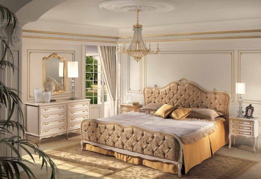 This picture reflects the stylish interior of the bedroom with big bed, luxury armchairs and wall decorations.