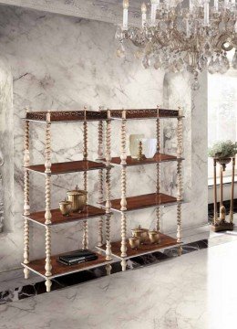 The picture shows a luxurious dining room with white marble flooring, a beautiful large chandelier, and a round wooden table adorned with a floral centerpiece. The walls have a sophisticated beige finish, and the furniture is upholstered with a rich velvet fabric. On the left side of the room is an ornate mirror mounted to the wall, along with two tall wooden cabinets for additional storage.