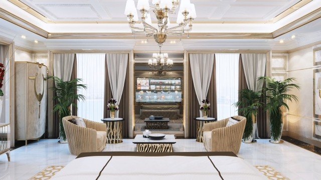 This picture shows a luxurious, spacious room with grandiose decor. The focal point of the room is the large chandelier that hangs from the ornate ceiling above. The walls feature elegant wallpaper with gold and white accents. The floor is polished marble tiles. At the center of the room is a seating area with a intricately designed settee and two armchairs upholstered in velvet. There is also a large, ornate table and several small side tables. The room is filled with a variety of artwork, sculptures, and other lavish decorations.