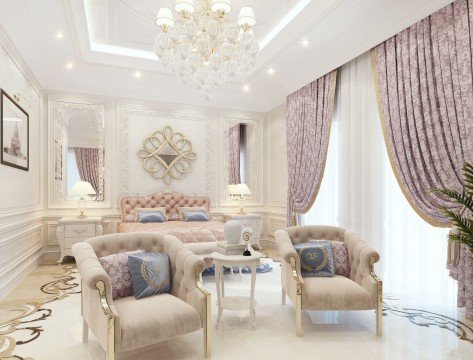 This picture shows an opulent living room with beige walls, cream leather furniture and lots of stylish decor and accessories. The ceiling is elaborately decorated with a gold chandelier and ornate carvings, while the room also features elaborate crown moulding, patterned throw pillows, and a white tiled floor with a stylish rug in the center. Two large windows let in plenty of light, making the room appear bright and inviting.