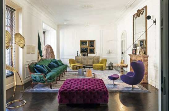 Luxurious living room with golden decorations and a cozy sofa, marble floor and big modern chandelier.