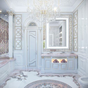 This picture shows a luxurious interior design. It is a bright white and gold design with a distinct Mediterranean-style. The room features a grand staircase with an intricate iron and wood railing leading to the second floor. There is a modern and comfortable seating area at the top of the stairs in front of an ornate fireplace. The walls are adorned with unique art pieces and decorated with elegant sconces. The floor is made up of large travertine tiles, giving it a polished and sophisticated look.