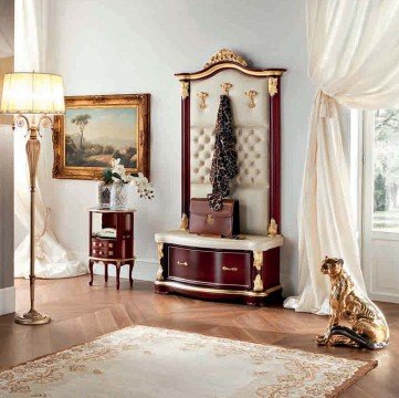 This picture shows a modern living room with sleek furniture and an abundance of clean, neutral colors. The room features two armchairs upholstered in white and beige fabrics, two large floor lamps, and a light gray sectional sofa. The walls are painted in a pale gray shade, and the room is filled with patterned rugs and accessories. The overall effect is one of contemporary elegance and sophistication.