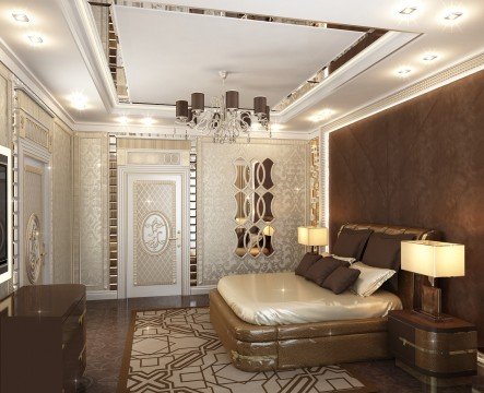 This picture shows a luxurious and modern interior design in a living room, featuring an elegant and cozy leather sofa in white color complemented with an accent armchair with a turquoise velvet upholstery. The walls are adorned with golden-framed artworks and a large sputnik-style chandelier adds an extra touch of glamour to the space. There is also a round coffee table with mirrored surface and a white faux fur rug that adds warmth and texture to the room.
