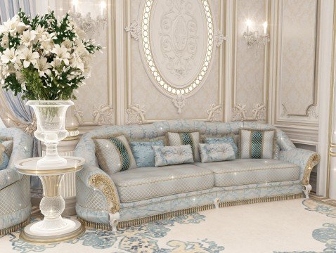 This picture shows a luxurious and modern living room. It has a white marble floor, a large beige sofa with several decorative pillows, a brown and gold ottoman, and two white armchairs with gold accents. A round crystal chandelier hangs from the ceiling, and there is a glass table between the chairs. On either side of the room are two windows with white draperies.