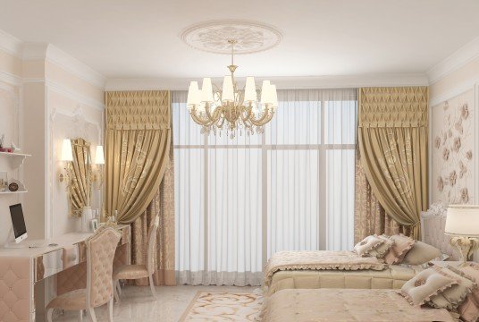 This picture displays a luxurious modern bedroom design featuring a regal bed with a lavish headboard. The bed is dressed with plush white bedding and finished off with a selection of soft cushions and an elegant fur blanket. There is also a beautiful crystal chandelier hanging from the ceiling, adding a touch of glamour to the room. The walls are painted a soft dove grey with subtle embellishments of silver. A large mirror hangs above the bed to add light and space to the room.