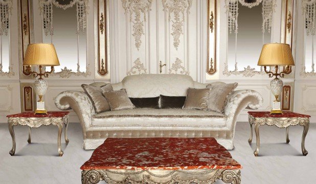 This picture shows a luxurious, modern staircase with a curved marble design and intricate iron railing. The staircase is lined with ornate golden accents, and the steps are covered with plush carpeting. At the base of the staircase, there is a cream-colored wall with panels of dark wood, gold embellishments and a large mirror at the top.