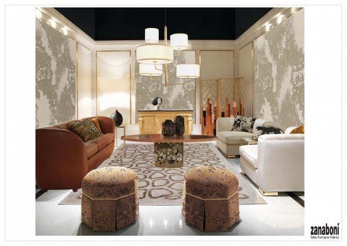 This picture shows a modern bedroom with light gray walls, a white ceiling, and a light hardwood floor. The room is furnished with a white bed frame with a tufted headboard and matching footboard, two white nightstands, a blue armchair, a white dresser, a mirror, and a floor length window. The room features indirect lighting along the edges of the ceiling, and a small pendant lamp in the center of the room.