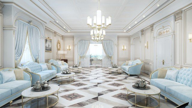 This picture is showing a luxurious interior design. There are two white couches facing each other, with a glass coffee table between them. A large painting hangs on the wall behind the couches, and a crystal chandelier hangs from the ceiling. The walls and ceiling are decorated with intricate molding and wood paneling. The floors are covered in a light-colored carpet, with a large area rug in the center of the room.