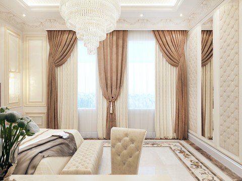This picture shows a luxurious living room with a modern design. The room features a white sofa and two armchairs, all placed on a beige and cream patterned rug. A rectangular mirrored coffee table, a decorative mirror, and a couple of additional decorative pieces are also present in the room. The walls are painted white and accented with gold wall art. Large windows allow plenty of natural light to come in, while a crystal chandelier hangs from the ceiling.