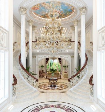 This picture shows an ornately decorated, luxurious and sophisticated living room. There is an intricately carved, ivory wall panel and two white leather armchairs placed beneath a gold mirrored archway. The lines of the archway are echoed by the sweeping curtains of an oversized window and a large, ornate chandelier hangs from the ceiling. The walls and floor feature a geometric marble pattern and a glass coffee table sits at the center of the room.