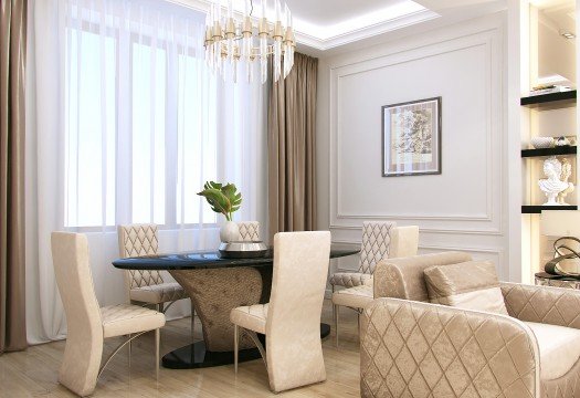 This picture shows an ornately decorated living room and dining room. The walls of the room are decorated with a cream and beige striped wallpaper and gold trim, and there is a marble fireplace in the corner with two decorative vases on either side. The furniture is a combination of light wood and white upholstery, and there are two crystal chandeliers overhead that add to the luxurious feel of the room. There are also several paintings and other pieces of art decorating the walls.