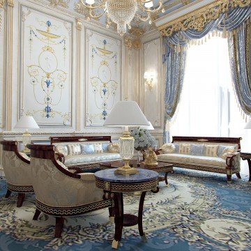This picture shows an ornate hallway with marble walls, luxurious furniture, and crystal chandeliers. The intricate details of the room's decor suggest a grand, opulent atmosphere. Large windows and an archway leading to an adjacent room open the area up to the outdoors, while richness of the interior design creates a sense of timeless luxury.