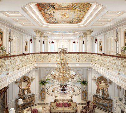 This picture shows a luxurious dining room, with two large crystal chandeliers hanging over a long dining table surrounded by eight chairs upholstered in rich, deep blue velvet. The floor is covered in an ornate rug, the walls are painted in a warm, golden hue, and there are large windows along one wall, allowing natural light to flood the space. The room is finished off with a stately white fireplace illuminated by two elegant sconces on either side.