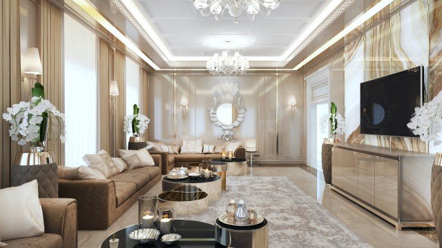 This is a picture of an elegantly designed room inside a home with various luxury touches to it. The room has white walls and a dark wood floor, with several comfortable chairs in the foreground and some shelves with decorative items in the background. In the center of the room is a large round marble table surrounded by four chairs with dark leather upholstery. The table also has a small ornamental tree on top with bright pink flowers, adding a touch of color to the otherwise neutral room.