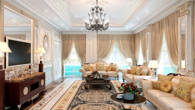 This picture shows a luxurious interior design of a room with a curved staircase and a skylight. The staircase is made of white marble steps that are encased by brass handrails and dark wooden railings. To the left of the staircase is a blue plush velvet sofa and two arm chairs with a white marble coffee table in the center. On the wall to the right of the staircase is a modern stone fireplace with a large mirror hanging above it. There is also a round crystal chandelier that hangs from the center of the skylight.