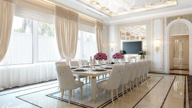 This picture shows a circular dining room table set with white china dishes, silverware, and wine glasses. There is a wooden centerpiece featuring several red roses. A white cloth napkin is folded on each plate, and four chairs with upholstered seats surround the table.