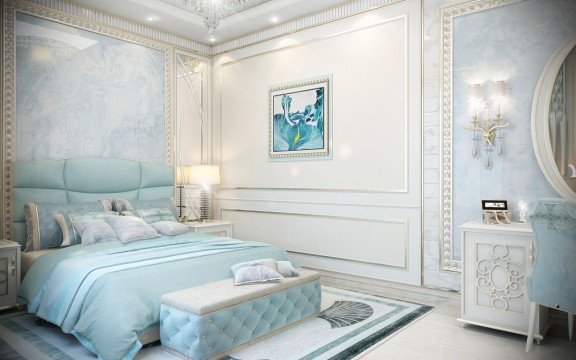 This picture shows a luxurious bedroom designed by Antonovich Design in Dubai. The room features sleek and modern furnishings, including a chic white and gold bed frame with a white tufted upholstered headboard, and two elegant side tables topped with glass lamps and artfully arranged accessories. The walls are finished in a deep and rich grey color, and the floor is covered with an intricate beige rug. For added luxury, the room also includes a beautiful crystal chandelier hanging from the ceiling.