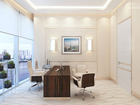 This picture is of a luxurious dining room with a large round table and leather white chairs. The table is made of dark wood and has a glass top, allowing light to flow through the room. The walls are decorated with elegantly framed gold-framed artwork and the hardwood floors are covered with a plush beige carpet. A chandelier overhead completes the look of sophistication and luxury in this space.