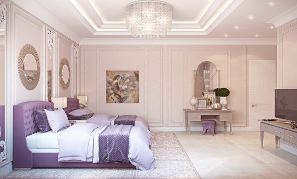 This picture shows an elegantly-designed living room with neutral tones. The sofa is upholstered in light gray with two accent pillows and a patterned throw blanket draped over the armrest. There is a black coffee table with a large glass top in the center, accompanied by two black ottomans. The cabinetry along the walls is pale gray and features several shelves for displaying decor and storing books. A modern white armchair is placed in the corner of the room, and a small round rug ties the whole look together.