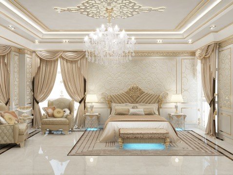 This picture shows a luxurious living area with a marble floor and walls, ornate gold accents, and a luxurious cream-colored sofa and chairs. There is a large chandelier hanging from the ceiling and a round marble coffee table in the center of the seating area. The room also features a matching set of armchairs, a decorative fireplace, and a large window overlooking an outdoor terrace.