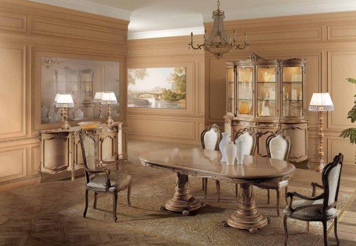 This picture is showing a contemporary marble staircase with a curved design. It has wooden floors with beige and white marble walls along the sides of the stairs. The wooden banisters have an intricate gold trim that adds a touch of elegance to the design. The walls also feature recessed lighting and a large arched window at the top of the staircase that brings in natural light.