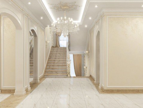 This picture shows a luxurious staircase with a unique curved design, made with intricate detailing on the handrail and steps. The stairs have a dark marble finish, with the balusters painted in a metallic black color to add a modern contrast. At the top of the stairs is an archway that is made of light marble, with white and gold accents. There are also two vases at the base of the stairs with vibrant pink flowers.