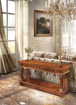 This picture shows the interior of a luxurious bedroom. The room is decorated in classic style with dark wood furniture and a traditional decorated bed. The bed has several pillows and an ornate headboard. There are curtains hanging from the windows and decorative wall hangings on the walls. The floor has a tiled pattern and a large, ornate rug in the middle. On the nightstand, there are two lamps and a small vase with flowers.