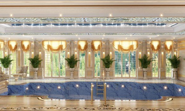 This picture shows a luxurious bedroom with a white and gold theme. The walls are covered in a light grey and white striped wallpaper, and there is a large floor-to-ceiling window on one side of the room. In the center of the room is a white canopy bed with gold accents and plush bedding. The bed is flanked by two decorative nightstands and two white armchairs. A modern chandelier hangs over the bed, adding a touch of elegance to the space.