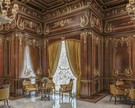 This picture shows a luxurious living room with cream and gold accents. The room is richly decorated with ornate furniture, including an upholstered sofa, a coffee table and armchairs, and a grandiose fireplace. The room is accented with accents of gold, including the chandelier and curtain rods, as well as a large gold framed wall mirror. The room also features several stylish accessories, such as a tall floor lamp, a decorative bowl, and a stylish vase with flowers.