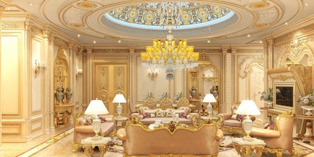 This picture is showing a luxurious and modern living room. The color scheme features mainly white, gold, and beige, along with pops of blue in the pillows and artwork. The walls feature white wainscoting and a large golden-framed mirror. The furniture includes matching white armchairs, a sofa, and a coffee table, with a statement piece of artwork above the sofa. There is also an ornate chandelier hanging from the ceiling to complete the look.