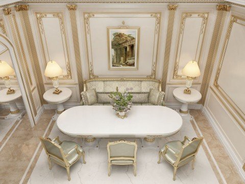 This is a picture of a modern, luxurious living room. It features plush off-white leather couches and chairs arranged around a matching coffee table and two white side tables. There is a gold-framed beveled mirror hung on the wall behind the seating area, and two ornately framed oil paintings hanging above it. The walls are painted in a light grey shade and feature large windows with floor-to-ceiling curtains. On the left corner of the room, a white marble fireplace is built into the wall.