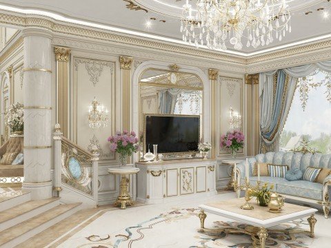 This picture is of a luxurious living room featuring elegant furnishings. The room is decorated with a neutral color palette of white, beige, and cream, adding to the feeling of sophistication. The flooring is covered in grey marble tiles, and the walls are white with wood paneling and molding. A large chandelier lights up the room, and several large windows add natural light. The furniture includes an ornate sofa and two matching armchairs, a white circular table in the center, and two wall-mounted shelves displaying various decorative items.