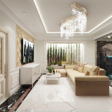 This picture shows a modern white and gold living room. The room is decorated with white walls and ceiling, and the floor is covered with a white fur rug. There are two white couches around a glass low-profile coffee table. On the wall behind the couches are several mirrors surrounded by a gilded frame which reflects the light from several white lights on the ceiling. Decorative flower arrangements and white pottery can be seen throughout the room, and there is a white ladder next to the couches which further adds to the modern eclectic style of the living room.