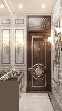 An elegant entrance to a modern, luxurious house. Marble columns and gold accents create a sophisticated look.