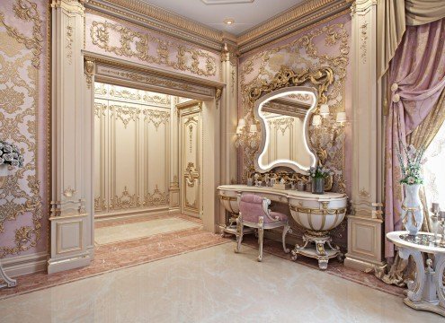 This picture shows an extravagantly designed bathroom featuring an ornate double vanity with marble countertop and a large mirror flanked by two decorative wall sconces. The walls are adorned with an intricate patterned tile and the floor is covered in a luxurious white and grey marble pattern. The room also features an opulent free-standing clawfoot tub.