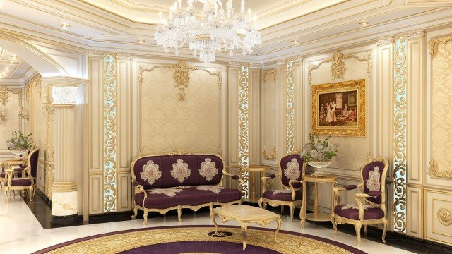 A luxurious interior space featuring a grand, curved stairway with ornately detailed balustrading, intricate chandelier lighting and plush, velvet seating arranged on a grey and white marble floor.
