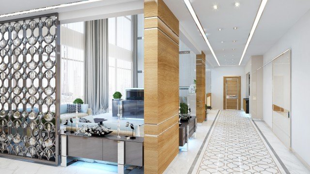 Modern luxurious interior design featuring bright marble floors, an ornate ceiling with components of gold and crystal chandeliers, combined with velvet furniture and floor-to-ceiling drapes.