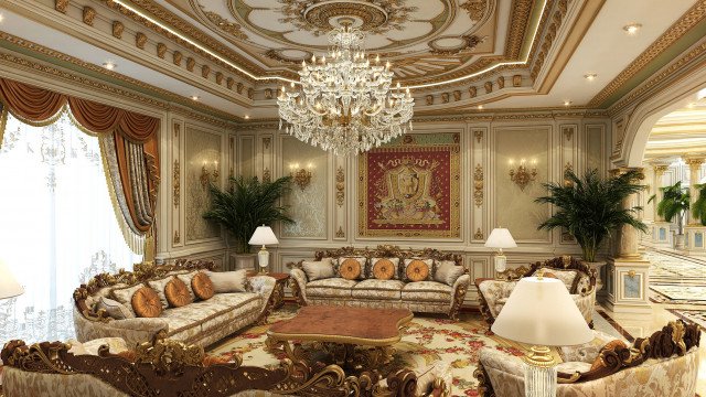 The picture shows a luxurious home interior. There is a grand staircase with a gilded balustrade and a crystal chandelier hanging from the ceiling. The walls are decorated with an ornate relief of gold and gray detailing, and there is a white marble floor with an elaborate rug in the center. The stairwell opens into a living room with oversized white furniture and a large fireplace.