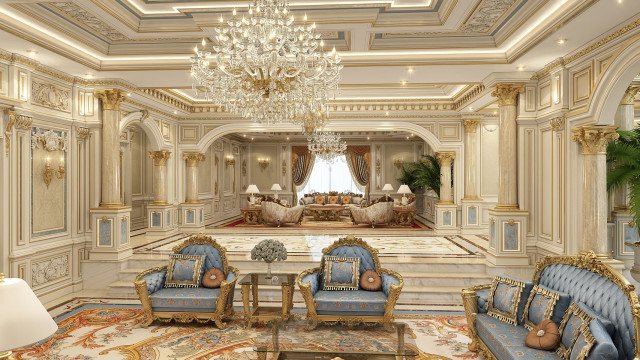 This picture shows a lushly decorated living room. The room is filled with luxurious furnishings, including a gold-colored sofa and chair set, an ornate wooden coffee table, a large crystal chandelier, and several white and gold chairs. There are also some plants in the corner of the room, adding to the room's elegant feel.