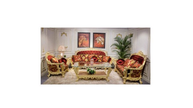 This picture shows an elegant and modern living room designed by Antonovich Design. The room is adorned with furniture of sophisticated lines and fabrics, with gold trimmings, intricate patterns, and luxurious textures. The walls are painted a soft white color, with dark accents in the form of furniture, painting, and decoration. The coffee table displays various objects, including ceramics, books, and decorative pieces. The overall atmosphere of the room creates a warm and inviting atmosphere.